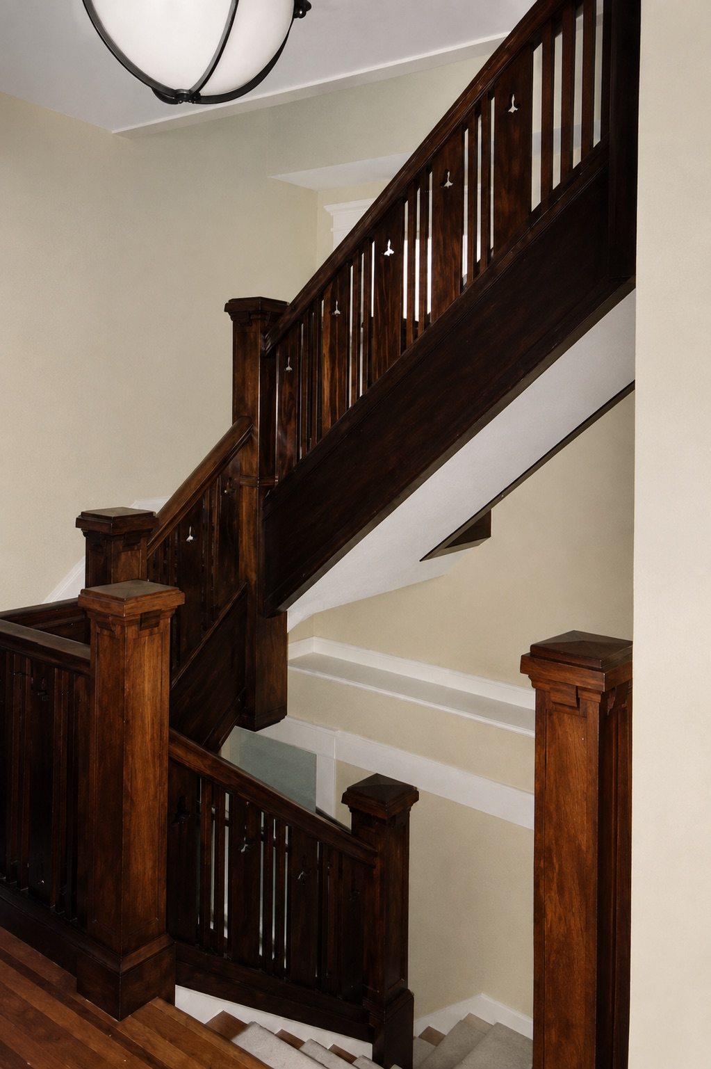 Custom stained hardwood staircase with square newel posts and railing