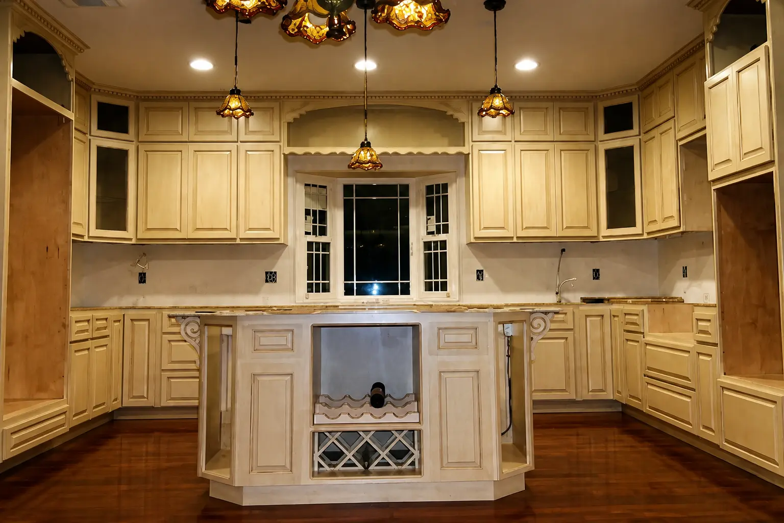 Cream glazed kitchen cabinets with a custom center island