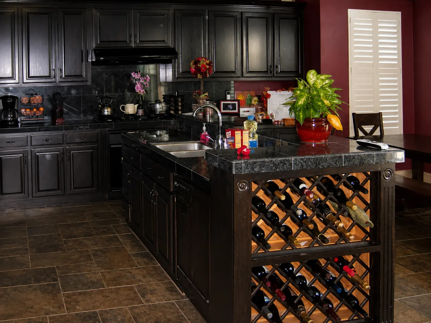 Dark espresso kitchen cabinets with a built-in wine rack island