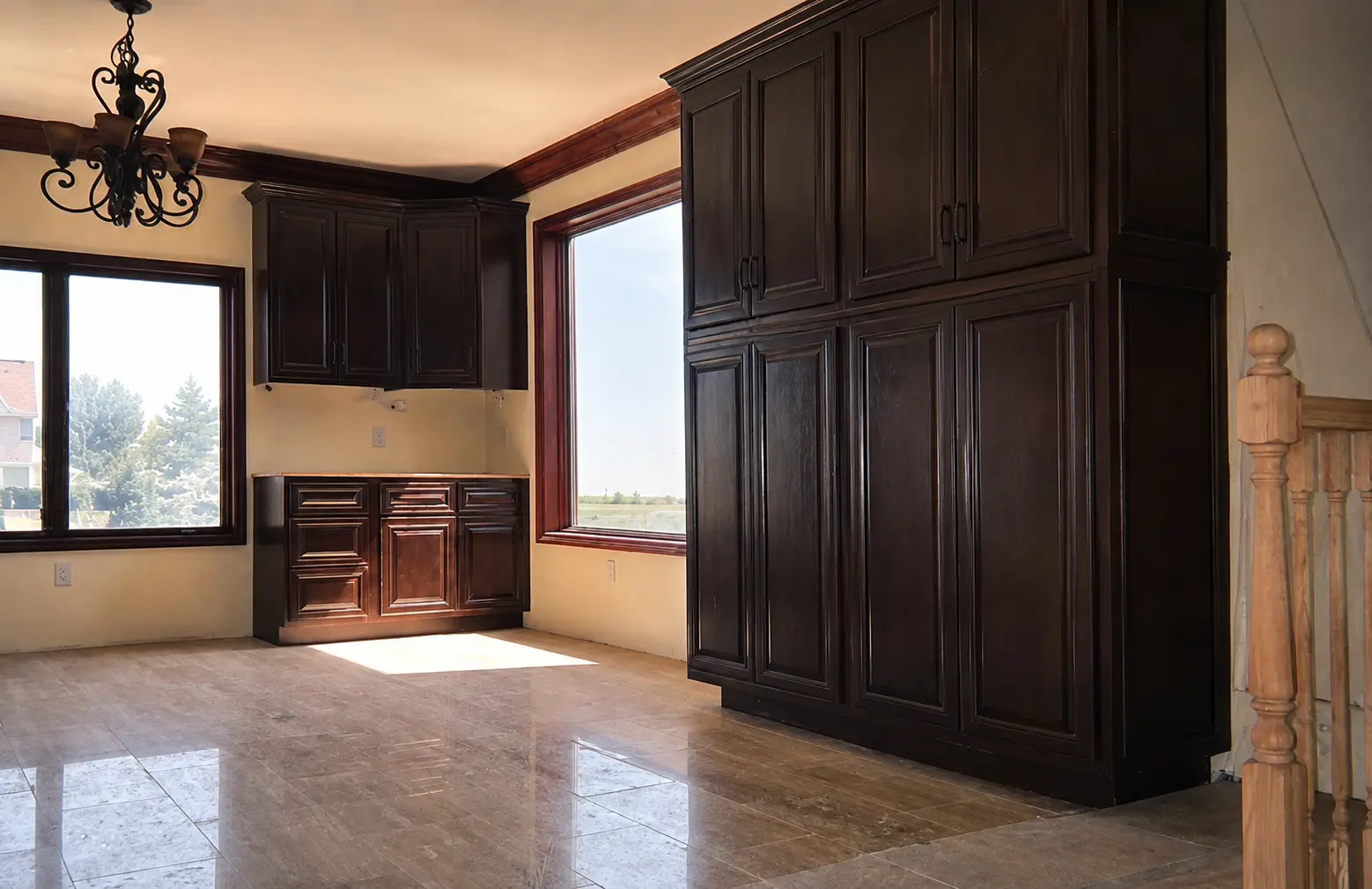 Floor-to-ceiling dark espresso pantry cabinetry with crown moulding