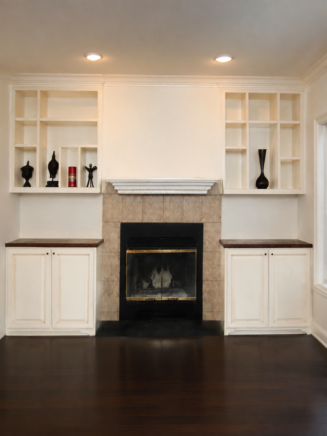 Custom white built-in cabinets and open shelving flanking a fireplace